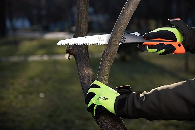 User sawing a tree limb with the Folding Hand Saw - Versatile Cutting Tool, featuring a non-slip ergonomic handle for safe handling.